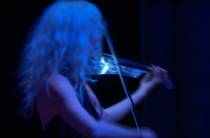 Ute Passionflower performing with her glowing electric violin